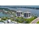 Aerial view of waterfront condos, tennis courts, and nearby homes at 501 N Causeway # 2050, New Smyrna Beach, FL 32169