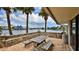 Outdoor patio with table and benches, overlooking waterfront with palm trees at 501 N Causeway # 2050, New Smyrna Beach, FL 32169