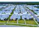 Aerial view of a community with many colorful houses and lush landscaping at 456 Lime Ave, Daytona Beach, FL 32124