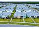 Aerial view of a community with pastel-colored houses and lush landscaping at 456 Lime Ave, Daytona Beach, FL 32124