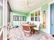Screened porch with wooden table and chairs at 456 Lime Ave, Daytona Beach, FL 32124