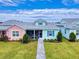 Quaint coastal cottage with light teal and pink exterior, screened porch, and brick walkway at 456 Lime Ave, Daytona Beach, FL 32124