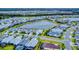 Aerial view of a neighborhood with houses and a central lake at 456 Lime Ave, Daytona Beach, FL 32124