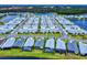 Aerial view of a community with houses surrounding a lake at 456 Lime Ave, Daytona Beach, FL 32124