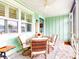 Relaxing front porch features a table and chairs, perfect for outdoor dining at 456 Lime Ave, Daytona Beach, FL 32124
