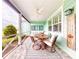 Inviting front porch with seating area, ceiling fan, and view of the landscaped yard at 456 Lime Ave, Daytona Beach, FL 32124