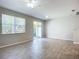 Living area with sliding glass doors, wood-look floors, and neutral walls at 679 Mount Olympus Blvd, New Smyrna Beach, FL 32168