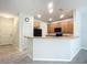 Modern kitchen with light gray walls, wood cabinets, and a breakfast bar at 679 Mount Olympus Blvd, New Smyrna Beach, FL 32168