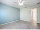 Spacious bedroom with light gray walls and wood-look tile floors at 679 Mount Olympus Blvd, New Smyrna Beach, FL 32168