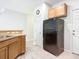 Kitchen area with black appliances and wood cabinets at 679 Mount Olympus Blvd, New Smyrna Beach, FL 32168
