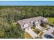 An aerial view showcasing a row of townhouses nestled in a wooded area at 679 Mount Olympus Blvd, New Smyrna Beach, FL 32168