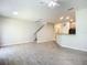 Open living room with gray walls, wood-look tile floors, and a staircase at 679 Mount Olympus Blvd, New Smyrna Beach, FL 32168