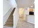 Carpeted staircase leading to the second floor with a view of entryway and kitchen at 679 Mount Olympus Blvd, New Smyrna Beach, FL 32168