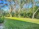 Backyard with lush lawn and mature trees at 679 Mount Olympus Blvd, New Smyrna Beach, FL 32168