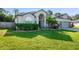 Two-story house with a three-car garage, manicured lawn, and landscaping at 510 Sun Lake Dr, Port Orange, FL 32127