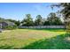Spacious backyard with fenced perimeter, lush grass, and a covered patio area at 510 Sun Lake Dr, Port Orange, FL 32127