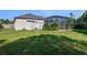 Spacious backyard with grassy area and screened pool at 510 Sun Lake Dr, Port Orange, FL 32127