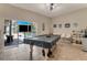 Game room features a pool table, wet bar, and sliding doors leading to a view of the backyard pool at 510 Sun Lake Dr, Port Orange, FL 32127