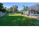 Large backyard with grassy lawn and screened pool at 510 Sun Lake Dr, Port Orange, FL 32127