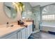 Elegant bathroom with dual sinks, a large shower, and a soaking tub at 510 Sun Lake Dr, Port Orange, FL 32127