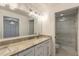 Bright bathroom boasts granite countertops, double sinks, and a walk-in shower at 2266 Hawks Cove Cir, New Smyrna Beach, FL 32168