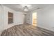 Bright bedroom with wood-look tile floors, double closets, and en-suite bathroom at 2266 Hawks Cove Cir, New Smyrna Beach, FL 32168