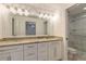 Elegant bathroom with double vanity, granite countertop, and walk-in shower at 2266 Hawks Cove Cir, New Smyrna Beach, FL 32168