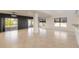 Open living room with tile floors and large windows offering natural light at 2266 Hawks Cove Cir, New Smyrna Beach, FL 32168