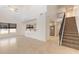 High-ceiling living room with open floor plan and view of kitchen and stairs at 2266 Hawks Cove Cir, New Smyrna Beach, FL 32168