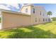 Tan house exterior with well-maintained lawn at 2266 Hawks Cove Cir, New Smyrna Beach, FL 32168