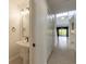 Small, updated powder room with pedestal sink and view of living area at 2266 Hawks Cove Cir, New Smyrna Beach, FL 32168