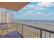 Oceanfront balcony with chair and table, offering breathtaking ocean views at 4141 S Atlantic Ave # 502, New Smyrna Beach, FL 32169
