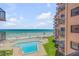 Inviting community pool with ocean views and surrounding lawn at 4141 S Atlantic Ave # 502, New Smyrna Beach, FL 32169