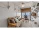 Living area with futon, ocean view, and built-in shelving at 4141 S Atlantic Ave # 502, New Smyrna Beach, FL 32169