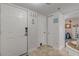 Bright entryway with white doors and nautical decor at 4141 S Atlantic Ave # 502, New Smyrna Beach, FL 32169