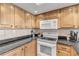 Kitchen with granite countertops and wood cabinets at 4141 S Atlantic Ave # 502, New Smyrna Beach, FL 32169