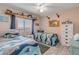 Guest bedroom with twin beds and coastal decor at 4141 S Atlantic Ave # 502, New Smyrna Beach, FL 32169