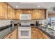 Kitchen with granite countertops and wood cabinets at 4141 S Atlantic Ave # 502, New Smyrna Beach, FL 32169