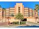 Multi-story building with parking garage and tropical landscaping at 4141 S Atlantic Ave # 502, New Smyrna Beach, FL 32169