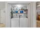 Laundry closet with washer and dryer, and storage shelving at 4141 S Atlantic Ave # 502, New Smyrna Beach, FL 32169