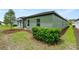 Side yard of the house with landscaping at 2352 Litchfield Loop, Deland, FL 32720