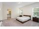 Main bedroom with a wooden platform bed and ample natural light at 2352 Litchfield Loop, Deland, FL 32720