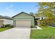 House exterior, two-car garage, and landscaped lawn at 2352 Litchfield Loop, Deland, FL 32720