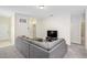 Spacious living room with grey sectional sofa and TV at 2352 Litchfield Loop, Deland, FL 32720