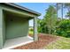 Covered patio with backyard access and wooded views at 2352 Litchfield Loop, Deland, FL 32720