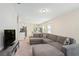 Bright and airy living room with sectional sofa and view into kitchen and game room at 2352 Litchfield Loop, Deland, FL 32720
