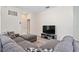 Open living room with sectional sofa and large TV, offering a spacious and comfortable area at 2352 Litchfield Loop, Deland, FL 32720