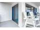 Balcony with white chairs and sliding glass doors at 5303 S Atlantic Ave # 270, New Smyrna Beach, FL 32169