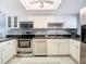Well-equipped kitchen with white cabinets and stainless steel appliances at 5303 S Atlantic Ave # 270, New Smyrna Beach, FL 32169