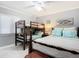 Bedroom with a double bed, bunk bed, and window at 5303 S Atlantic Ave # 270, New Smyrna Beach, FL 32169